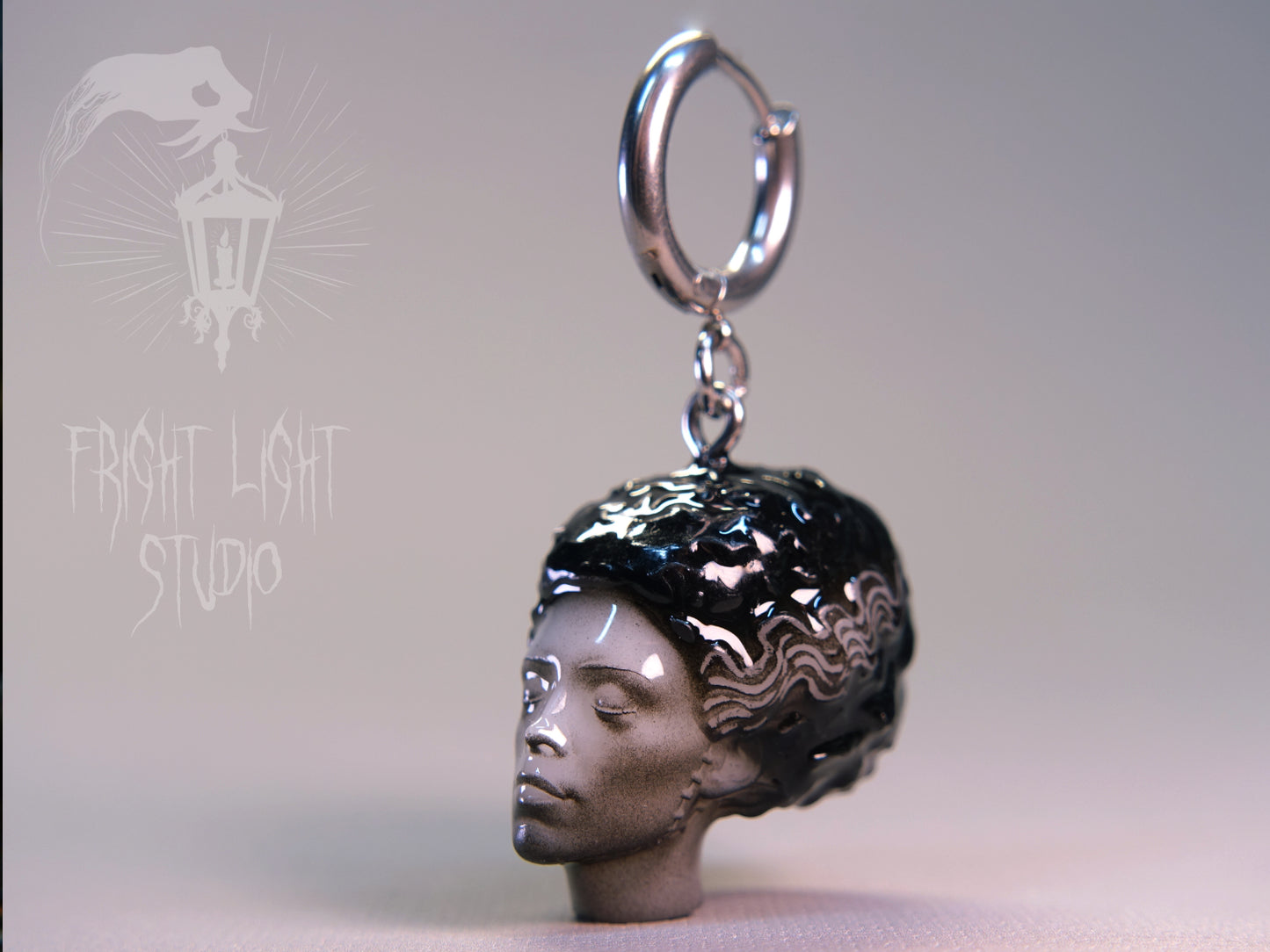 Bride of Frankenstein charm on a thin silver hoop.